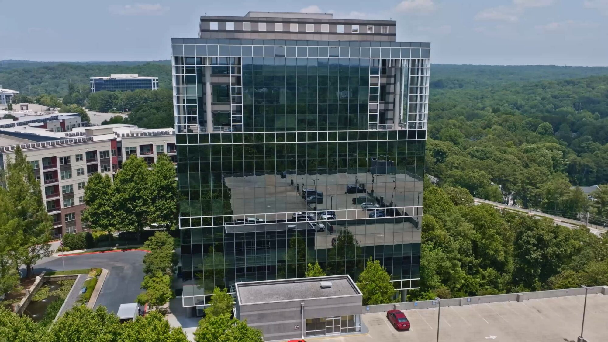 Aerial view of Porchlight's Atlanta office — a glass tower in Cumberland surrounded by trees — headquarters of the home improvement branding agency.